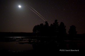 ISS and STS-133 climbing out of the western sky and entering the Earths shadow as they approach the lunar disk.