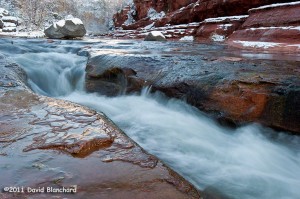 Water cascades through the sandstone, snow, and ice in Slide Rock State Park.
