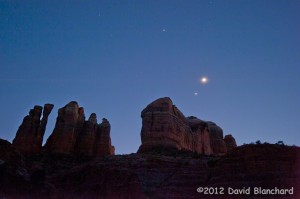 Jupiter, Venus, and the Moon shine brighly above Cathedral Rock in Sedona, Arizona.