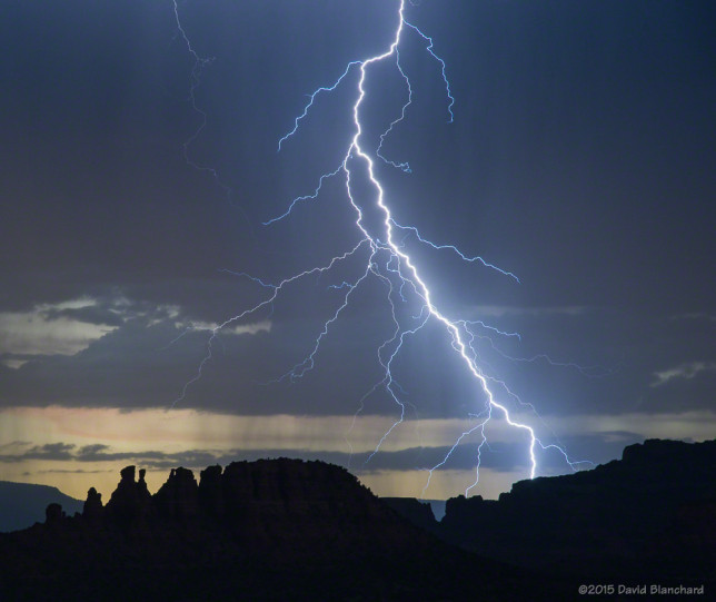 Lightning splits the sky behind the Cockscomb in Sedona, Arizona.