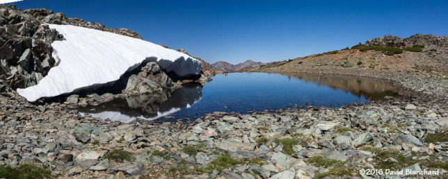 Panorama of the tarn and snow.