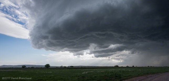 Two-image panorama of a weakly rotating storm updraft.