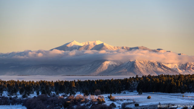 Fog and clouds wrap around the San Francisco Peaks.