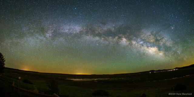 The Milky Way along with bands of airglow stretch across the eastern sky.