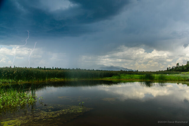 Lightning over Marshall Lake with the San Francisco Peaks in the distance.