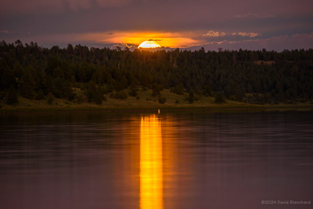 The Moon rises higher in the gap and casts a more diffuse reflection.