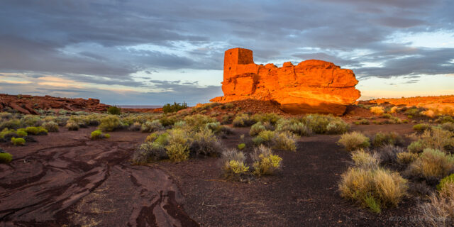 The setting Sun illuminates Wukoki Pueblo in Wupatki National Monument.