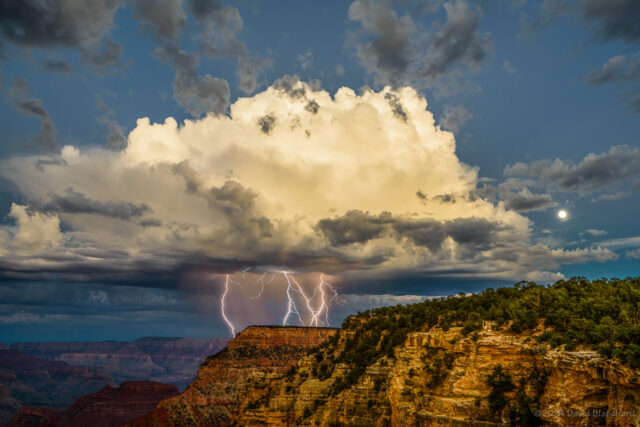 A thunderstorm produces multiple lightning strikes in Grand Canyon as the Moon rises above the clouds.