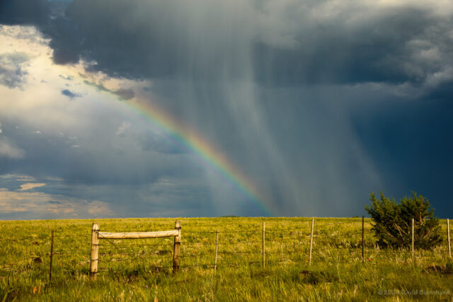 A partial rainbow over the grasslands of Anderson Mesa.