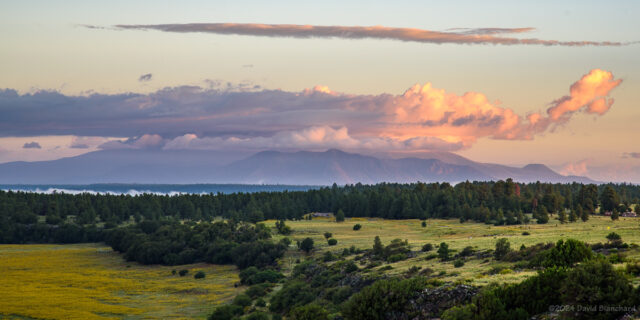 Clouds cap the San Francisco Peaks while fog lingers in the valleys near Lake Mary.