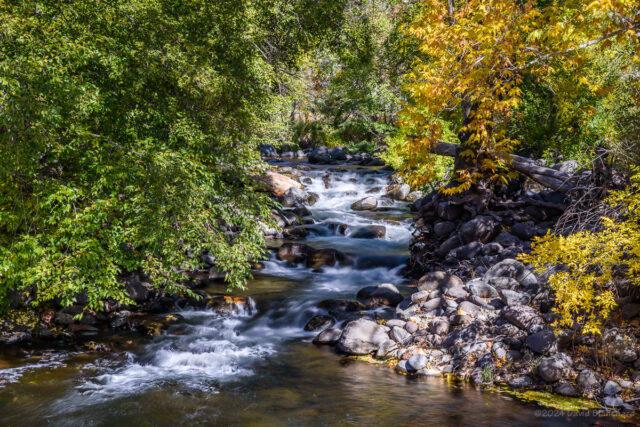 Water cascades over large boulders before entering a large and deep pool at Grasshopper Point in Oak Creek Canyon.