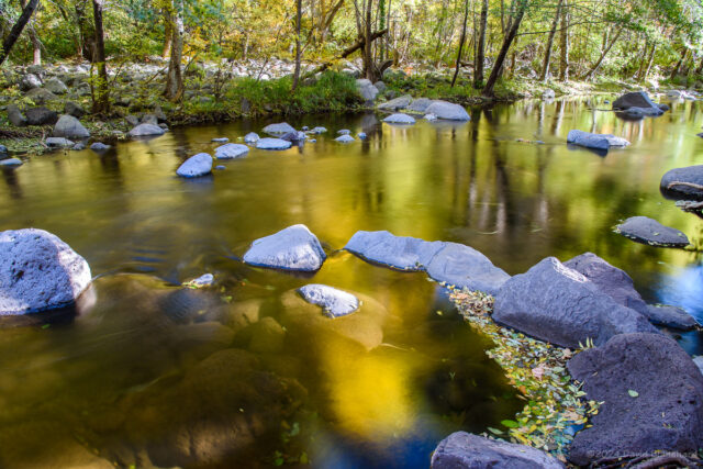 Late afternoon colors are reflected in the waters of Oak Creek.